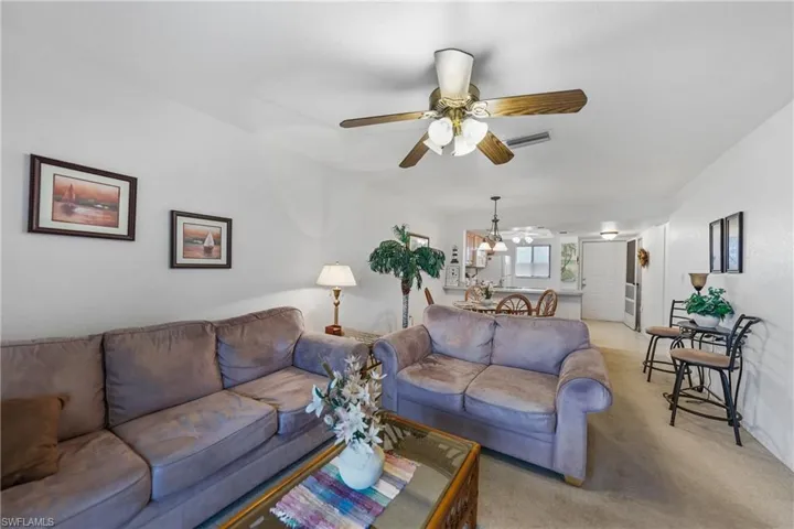 Living area with carpet flooring and ceiling fan