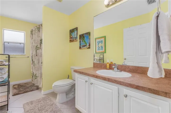 Bathroom with tile floors, vanity, and toilet