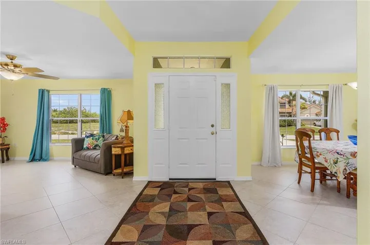 Foyer featuring light tile flooring and ceiling fan