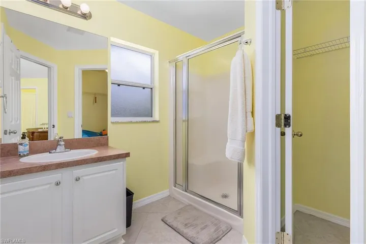 Bathroom with tile floors, an enclosed shower, and oversized vanity