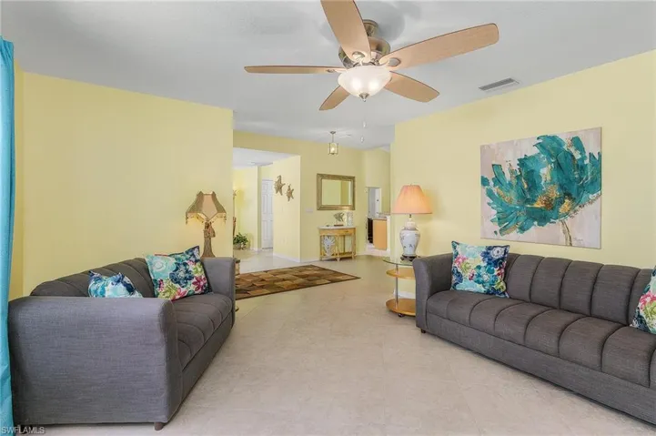 Living room featuring tile floors and ceiling fan