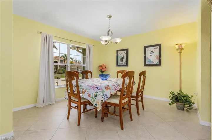 Dining area featuring a chandelier and light tile floors
