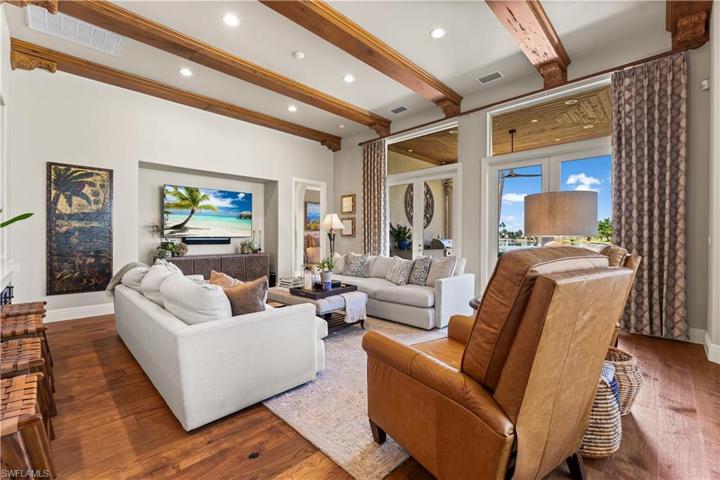 DE Chateau Wood Flooring, Custom Coffee Bar, Double French Glass Doors to Lanai and Pool Area.Custom Coffered Ceiling with Faux Wood Beam Accents & Recessed Lighting.