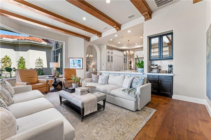 DE Chateau Wood Flooring, Custom Coffee Bar, Double French Glass Doors to Lanai and Pool Area.Custom Coffered Ceiling with Faux Wood Beam Accents & Recessed Lighting, Bay Window.