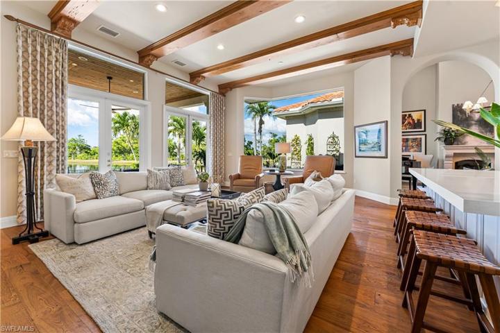 DE Chateau Wood Flooring, Custom Coffee Bar, Double French Glass Doors to Lanai and Pool Area.Custom Coffered Ceiling with Faux Wood Beam Accents & Recessed Lighting, Bay Window.