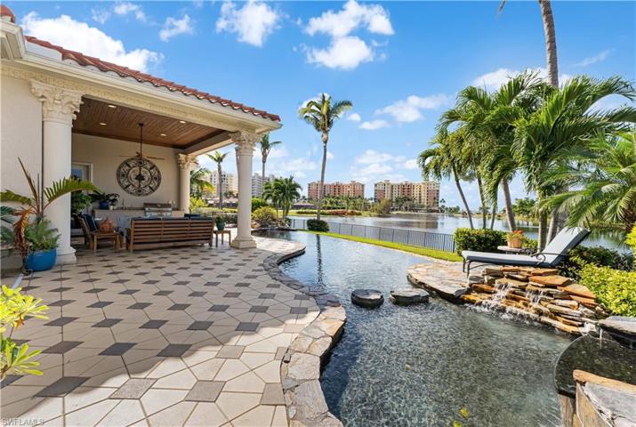 Pecky Cypress wood ceiling on your lanai with a outdoor kitchen with AOG (American outdoor grill), sink. Pavered pattern deck. INFINITY pool and spa w/2 rock waterfall features. Lake views.
