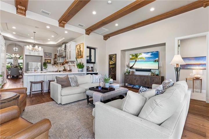 DE Chateau Wood Flooring, Custom Coffee Bar, Double French Glass Doors to Lanai and Pool Area.Custom Coffered Ceiling with Faux Wood Beam Accents & Recessed Lighting, Bay Window.