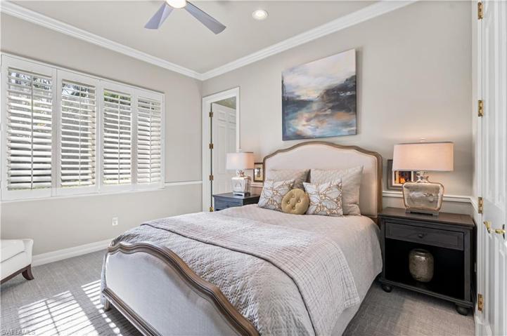 3rd bedroom offers plantation shutters, crown molding, carpet.