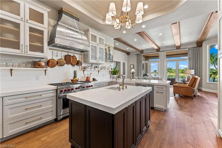 DE Chateau Wood Flooring, 20Ft Double Trey Coffered Ceiling W/Recess Lighting, Custom Cabinetry W/Soft Close Pull Out Drawers, Gold Fixtures, Quartz Counter Tops, Center Island W/Farm Sink 6 Burner WOLFE Gas Stove W/Coppersmith Hood,Bosch Dishwasher, Sharp Microwave, Pool and Lake views.