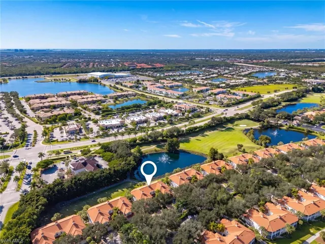 Aerial perspective featuring terracotta-style roofing, waterfront positioning, and proximity to expansive green space