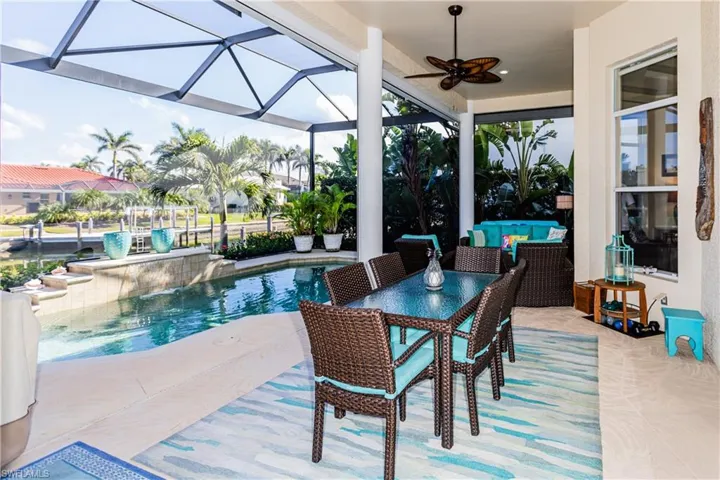 View of patio / terrace featuring ceiling fan, a lanai, and an outdoor pool