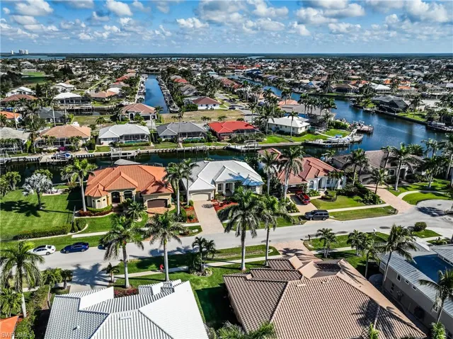 Birds eye view of property with a water view and a residential view