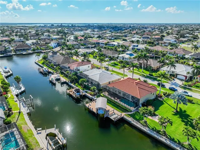Birds eye view of property with a water view and a residential view
