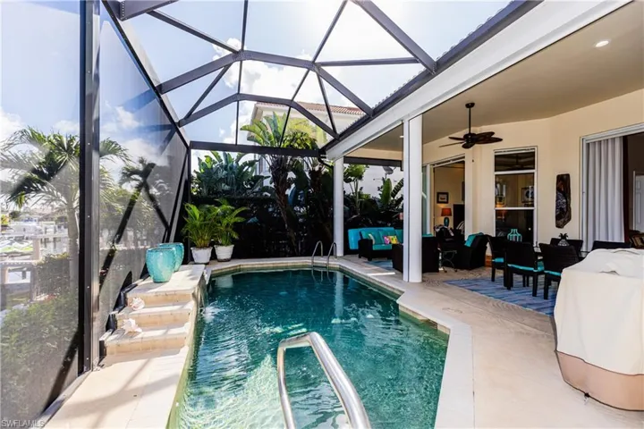 Outdoor pool with ceiling fan, a patio, an outdoor hangout area, and a lanai