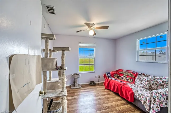 Living room with hardwood / wood-style flooring and ceiling fan