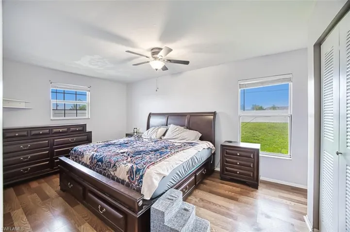 Bedroom with a closet, light wood-type flooring, and ceiling fan