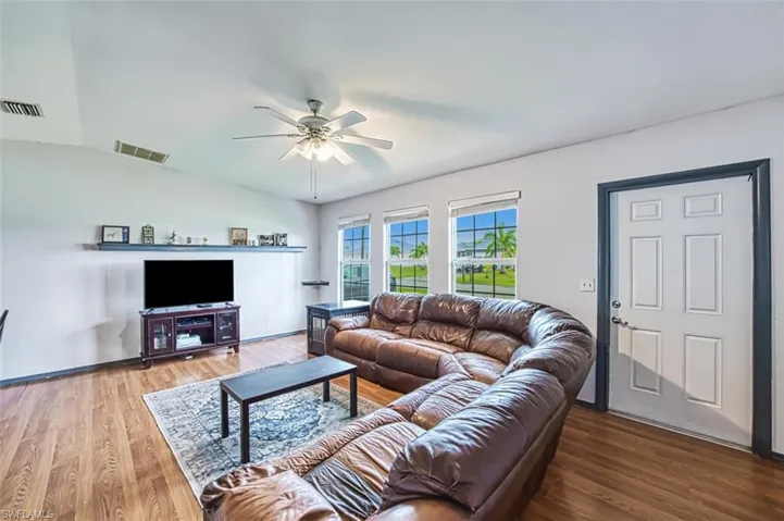 Living room featuring hardwood / wood-style floors and ceiling fan