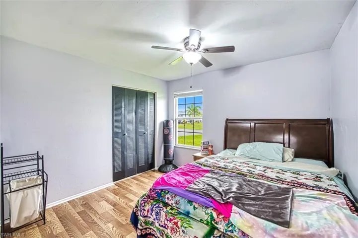 Bedroom featuring a closet, wood-type flooring, and ceiling fan