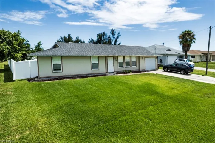 Single story home featuring a front lawn and a garage