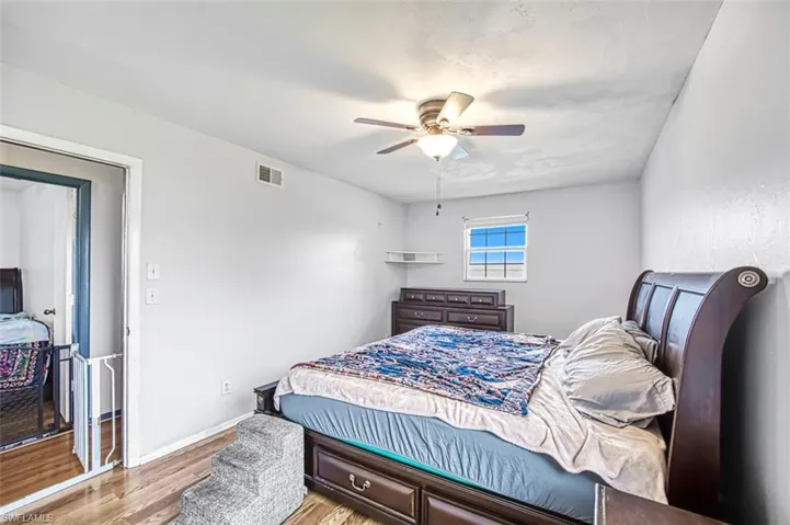 Bedroom featuring ceiling fan and light hardwood / wood-style flooring