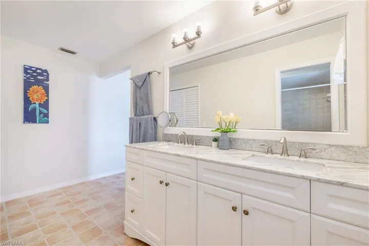 Bathroom featuring double vanity and a shower with curtain