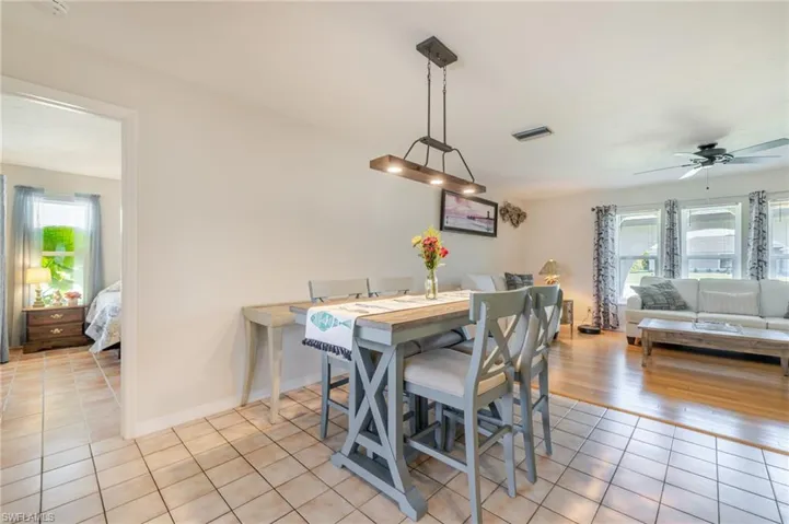 Dining room featuring light tile patterned flooring and ceiling fan
