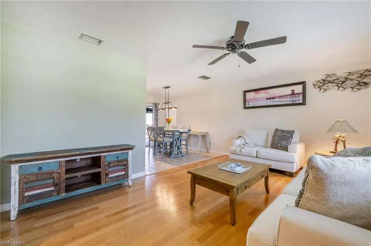 Living room with light wood-style floors and ceiling fan