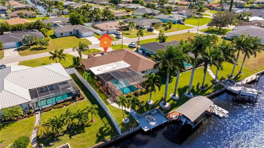 Aerial perspective of suburban area featuring a large body of water