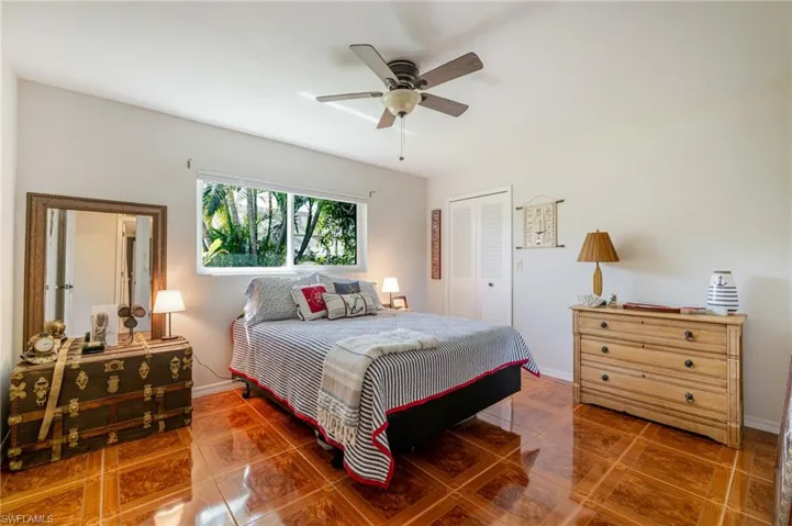 Bedroom with a closet, ceiling fan, and tile patterned floors