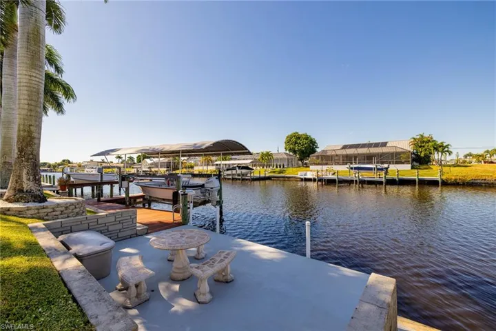 Dock area with boat lift and a water view