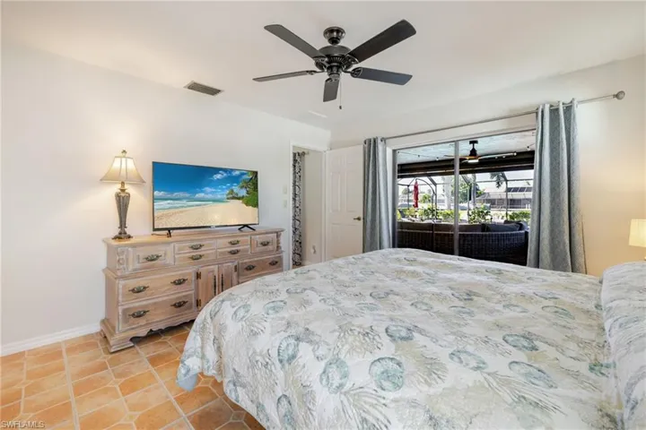 Bedroom featuring light tile patterned floors and a ceiling fan