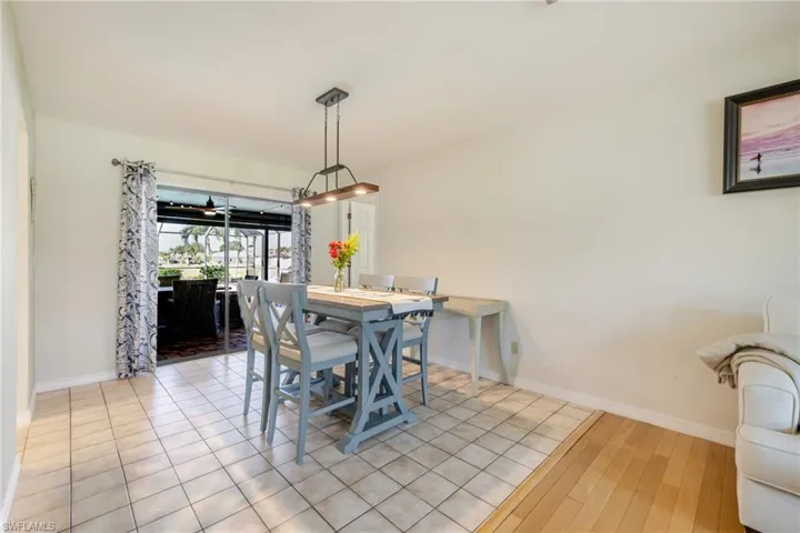 Dining space featuring light tile patterned flooring and baseboards