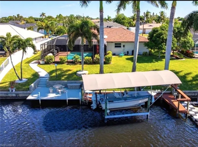 Dock area with glass enclosure and a water view