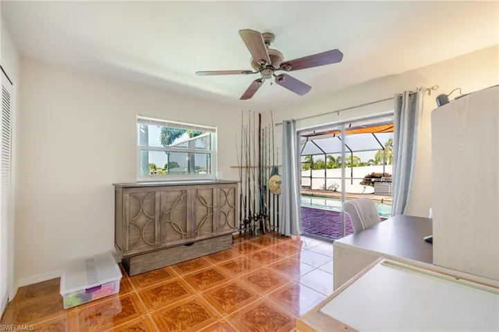 Office area featuring a sunroom, tile patterned flooring, healthy amount of natural light, and a ceiling fan