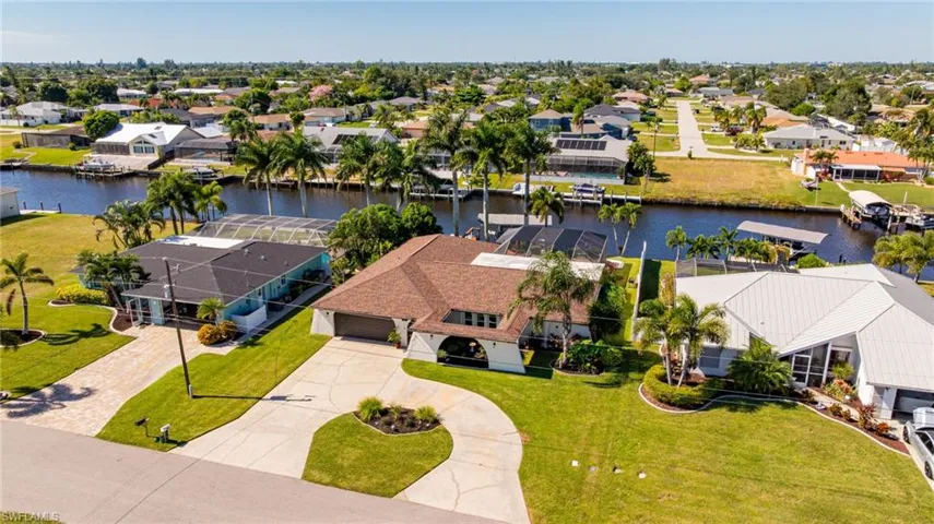 Aerial perspective of suburban area featuring a nearby body of water