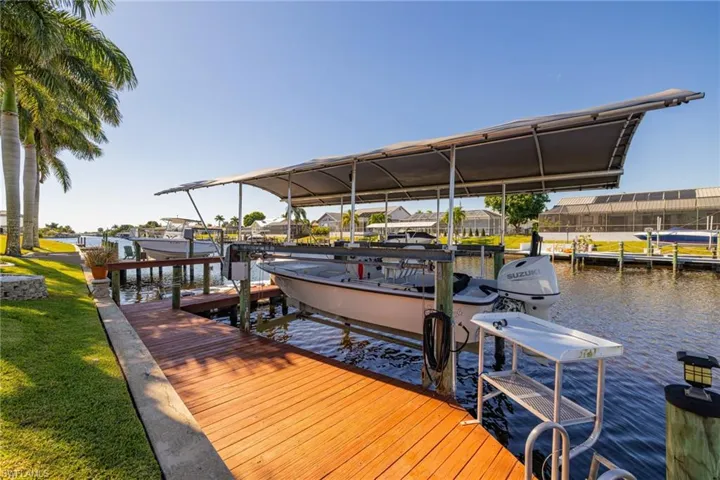 Dock area with boat lift and a water view