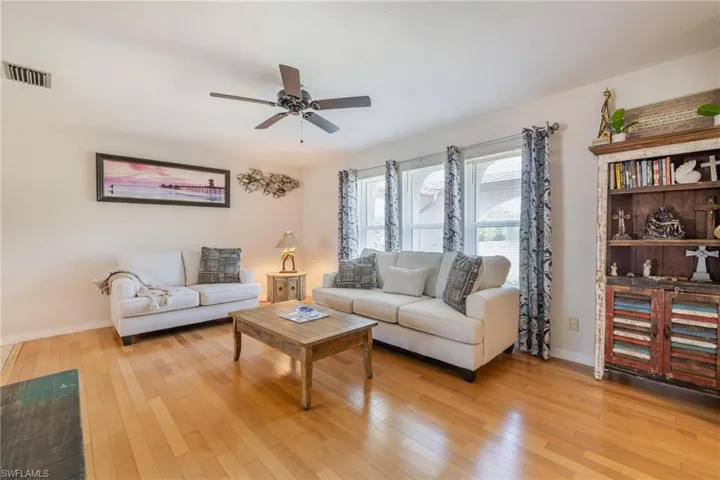 Living area featuring light wood-style flooring and ceiling fan