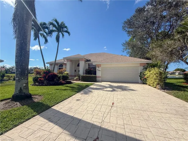 View of front of house with a garage and a front yard