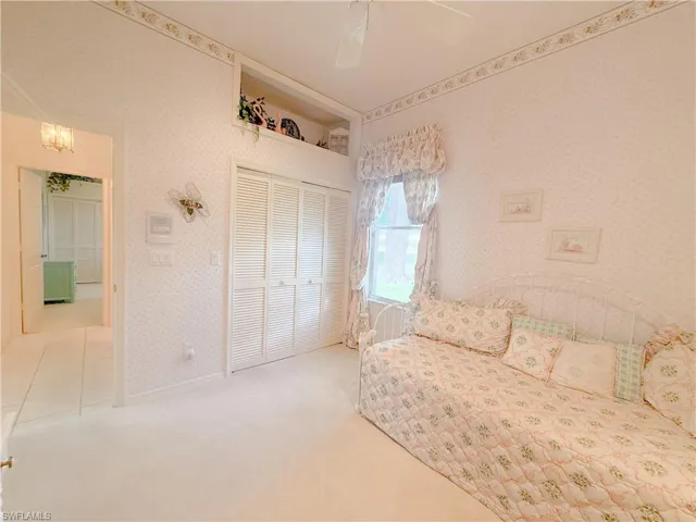 Unfurnished bedroom with ceiling fan, carpet floors, and a closet
