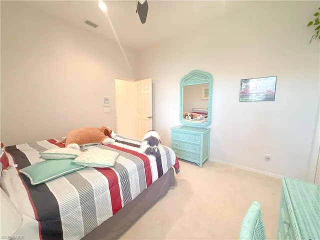 Bedroom with light carpet and ceiling fan