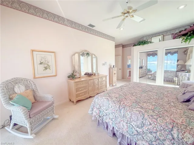 Bedroom featuring access to exterior, light colored carpet, and ceiling fan