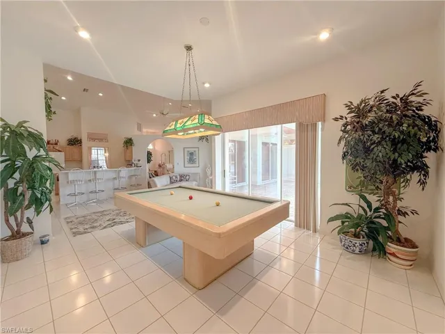 Playroom featuring light tile patterned floors, pool table, and a wealth of natural light