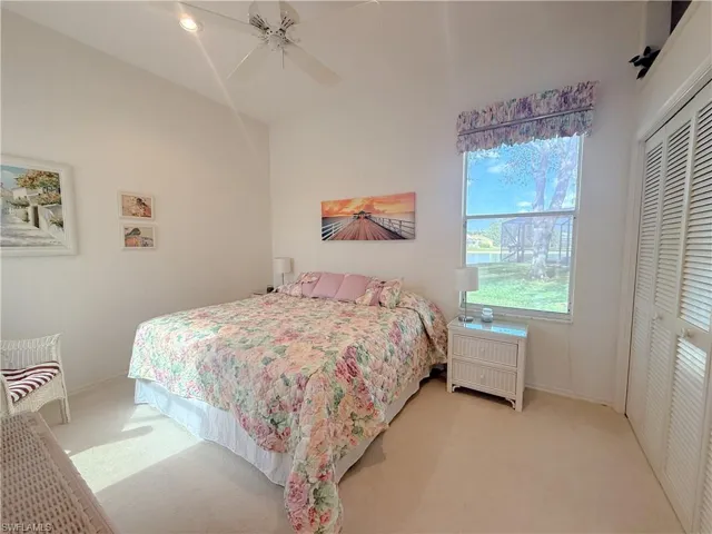 Carpeted bedroom featuring ceiling fan and a closet