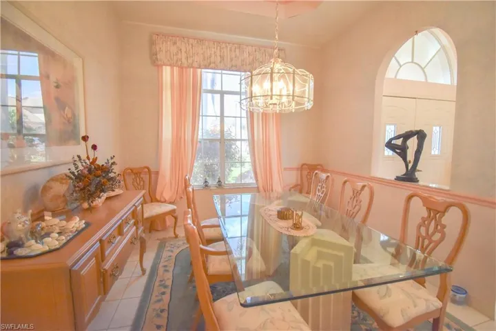 Dining room featuring light tile patterned flooring and an inviting chandelier