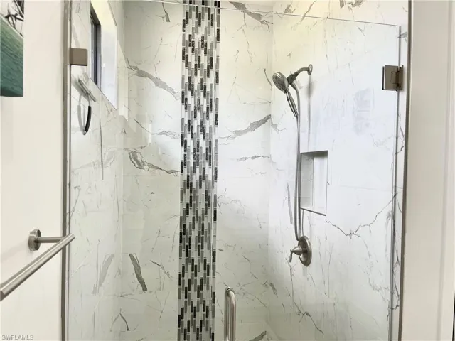 Interior details featuring an enclosed shower