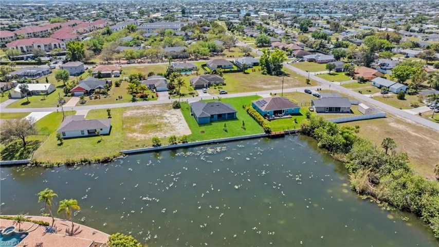 Aerial view featuring a residential view and a water view