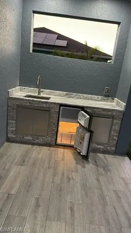Room details featuring hardwood / wood-style flooring and sink