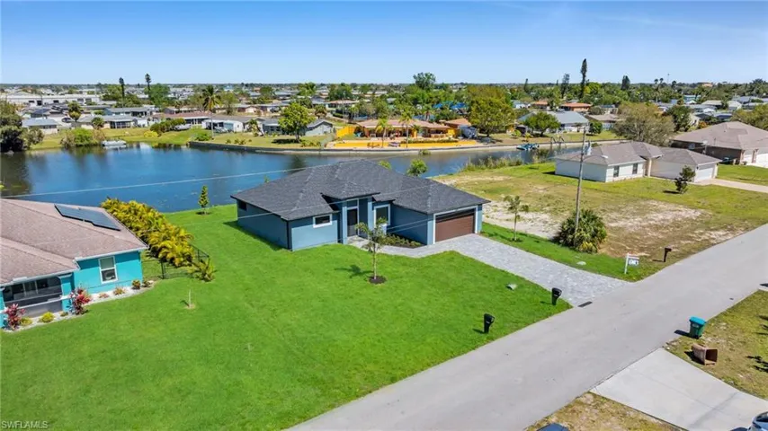 Birds eye view of property with a residential view and a water view