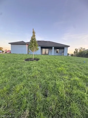 Ranch-style home featuring a yard