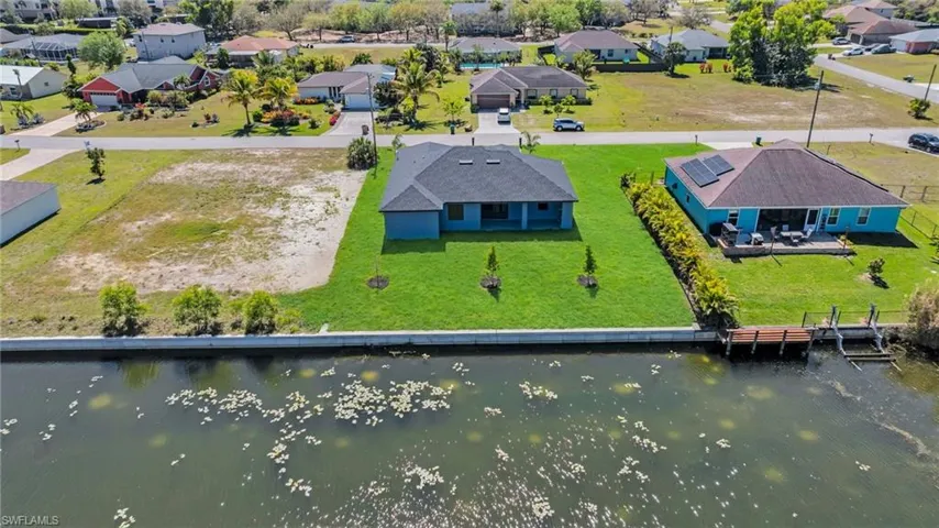 Drone / aerial view featuring a water view and a residential view